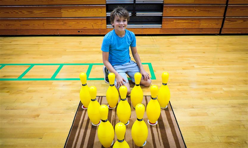 Students bowl in PE class